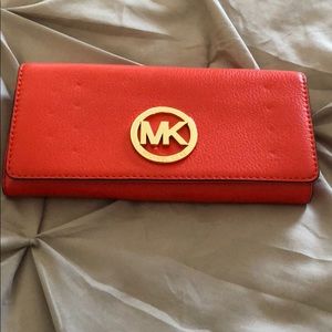 Michael Kors wallet in orange.